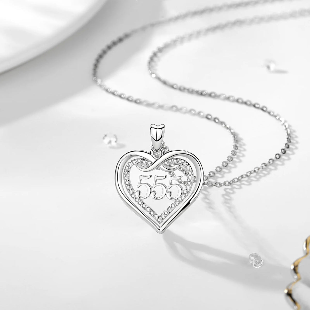 555 angel number heart necklace with polished silver outline and clear CZ stone accents