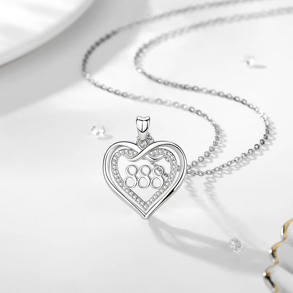 888 angel number necklace with a silver infinity heart and stone-set inner border