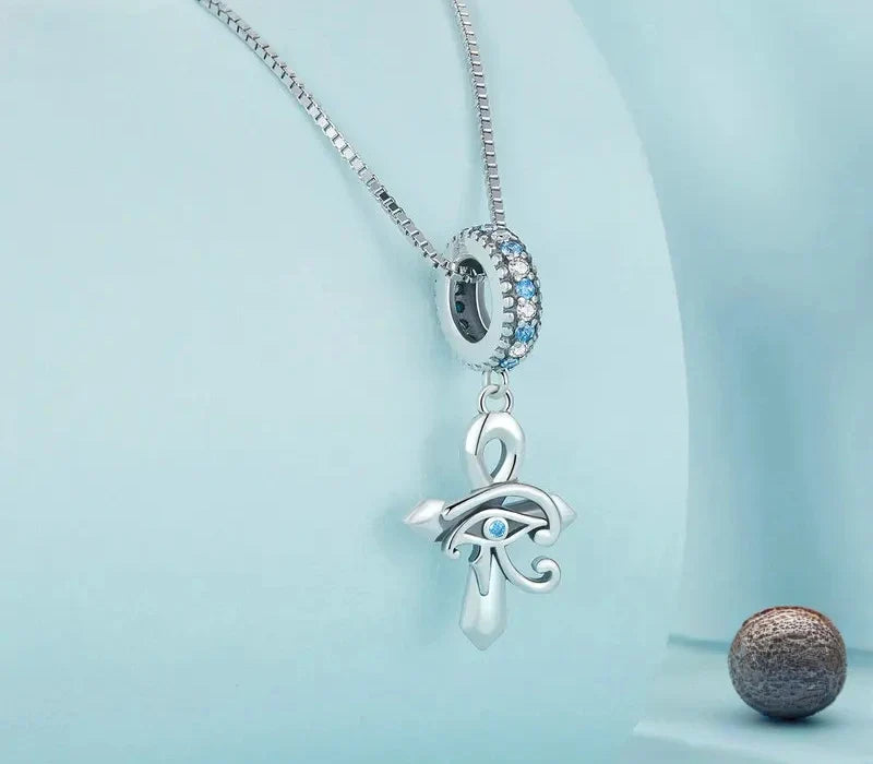 Angled view of the 925 sterling silver ankh necklace with Eye of Horus and blue stone details
