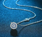 Close-up of the silver-tone necklace with a round blue and clear cubic zirconia evil eye medallion