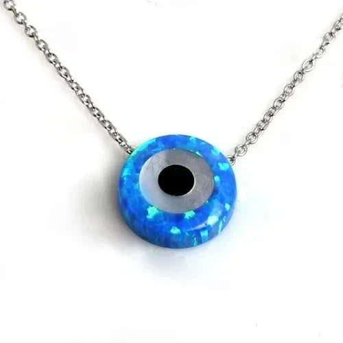 Round blue synthetic opal evil eye pendant on an open cable chain against a white background