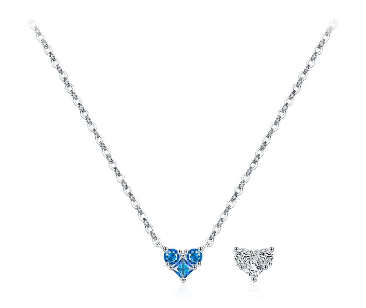 Bright blue CZ heart necklace with two round stones above the faceted heart