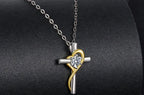 925 sterling silver cross pendant with gold-plated heart ribbon and moissanite on a dark necklace display