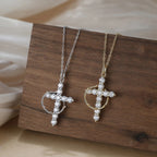 Crown of thorns cross necklaces in silver-tone and gold-tone, displayed on a wooden block