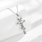 925 sterling silver crucifix necklace displayed on white curved props with textured cross details