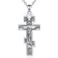 Detailed sterling silver crucifix hanging from a fine silver chain against a white background