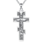 Detailed sterling silver crucifix hanging from a fine silver chain against a white background