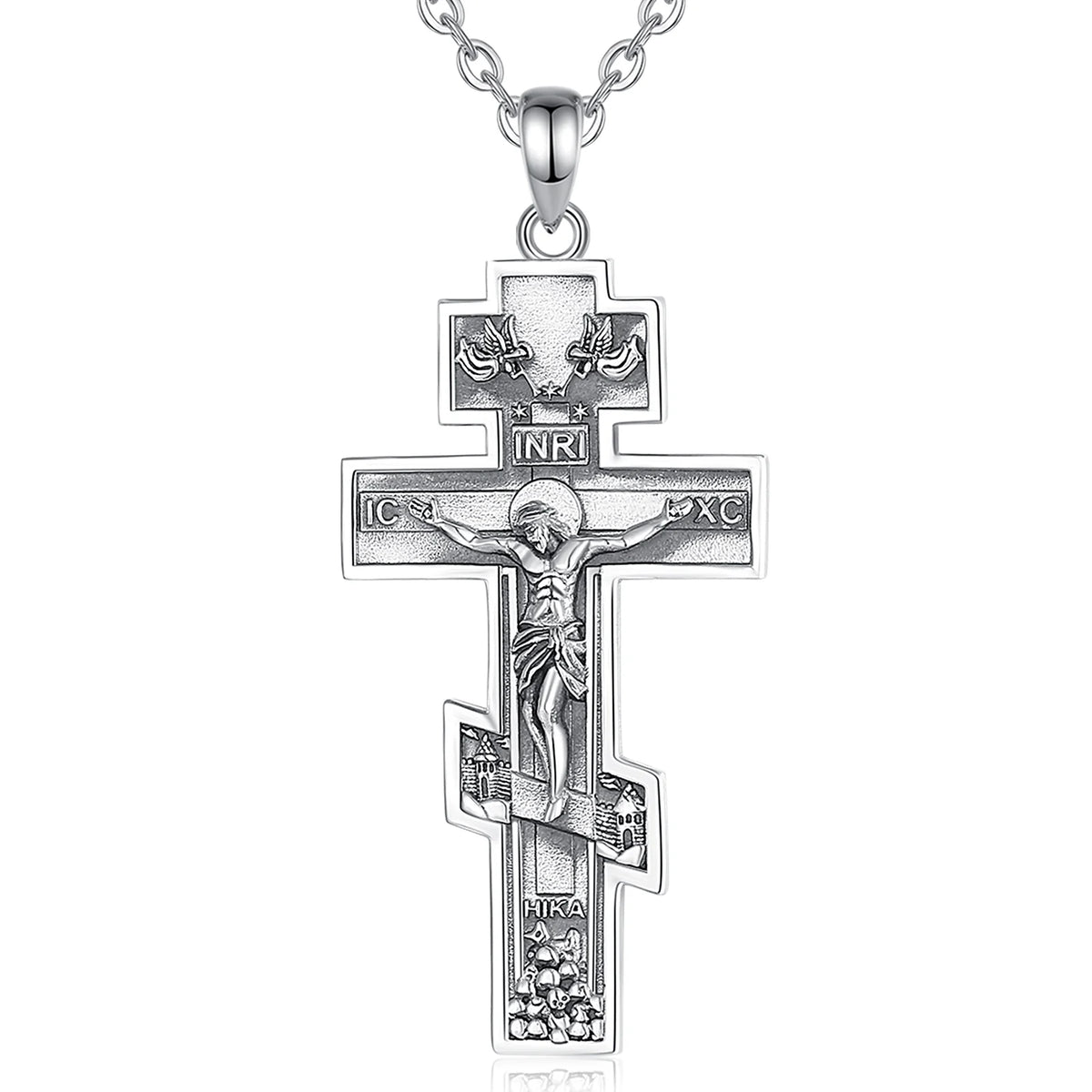 Detailed sterling silver crucifix hanging from a fine silver chain against a white background