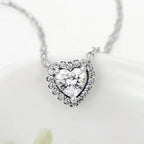 Front view of a cubic zirconia heart necklace with rounded prongs and a clear crystal stone halo
