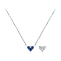 Dark blue CZ heart necklace on a fine silver chain beside a clear heart motif