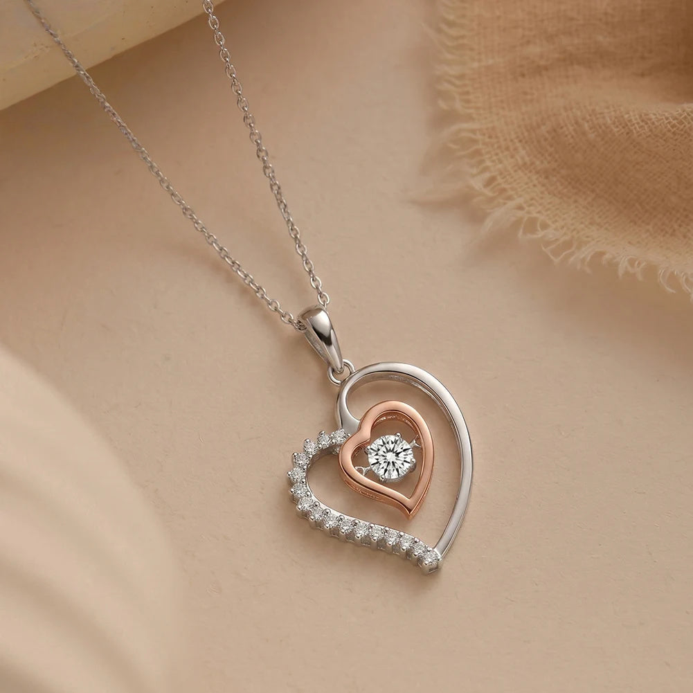 Close-up of the sterling silver double heart pendant with crystal stones along one outer curve