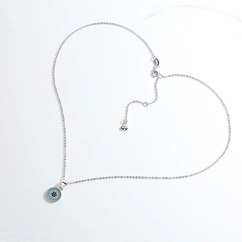 Silver-tone evil eye necklace arranged to show the oval-link chain, extender and lobster clasp