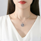 Openwork evil eye necklace worn at the base of the neck with a blue and white round pendant