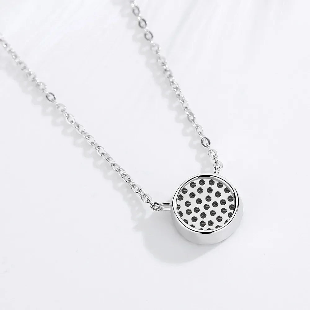 Back view of the silver-tone flower evil eye pendant showing its open perforated pattern