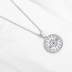 Back view of the silver-tone round evil eye pendant with open perforations behind the stones