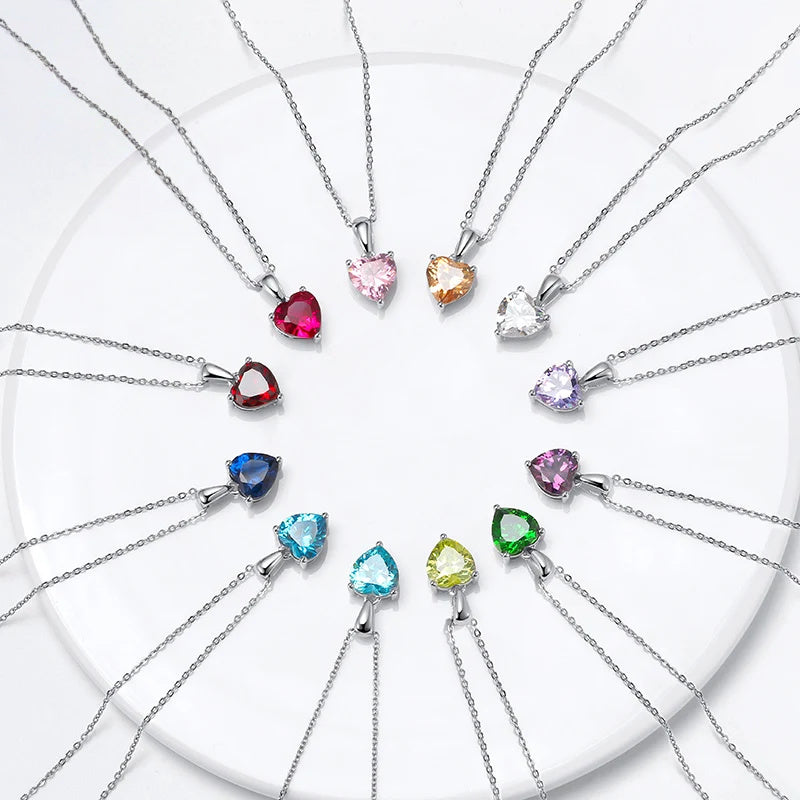 Faceted heart necklace color options arranged in a circle on a white background