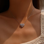 Sterling silver flower heart necklace worn on the neck, showing the pale pink stone cluster and sparkling border