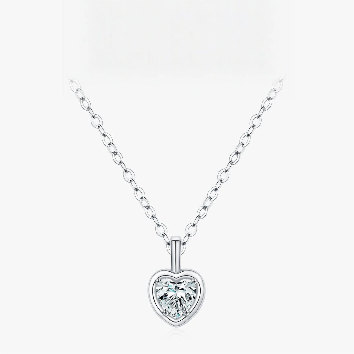Framed heart necklace in sterling silver with a clear CZ heart stone on a plain background