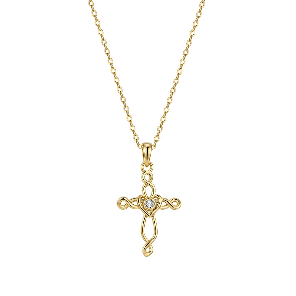Gold-tone Celtic cross necklace on white with woven open lines and a round clear heart-center stone