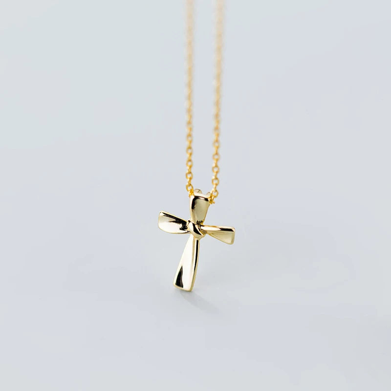Gold-tone 925 sterling silver cross pendant with polished flared arms and a fine link chain
