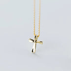 Gold-tone 925 sterling silver cross pendant with polished flared arms and a fine link chain