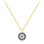 Gold-tone crystal evil eye necklace with a round pendant of blue and clear stones on a white background