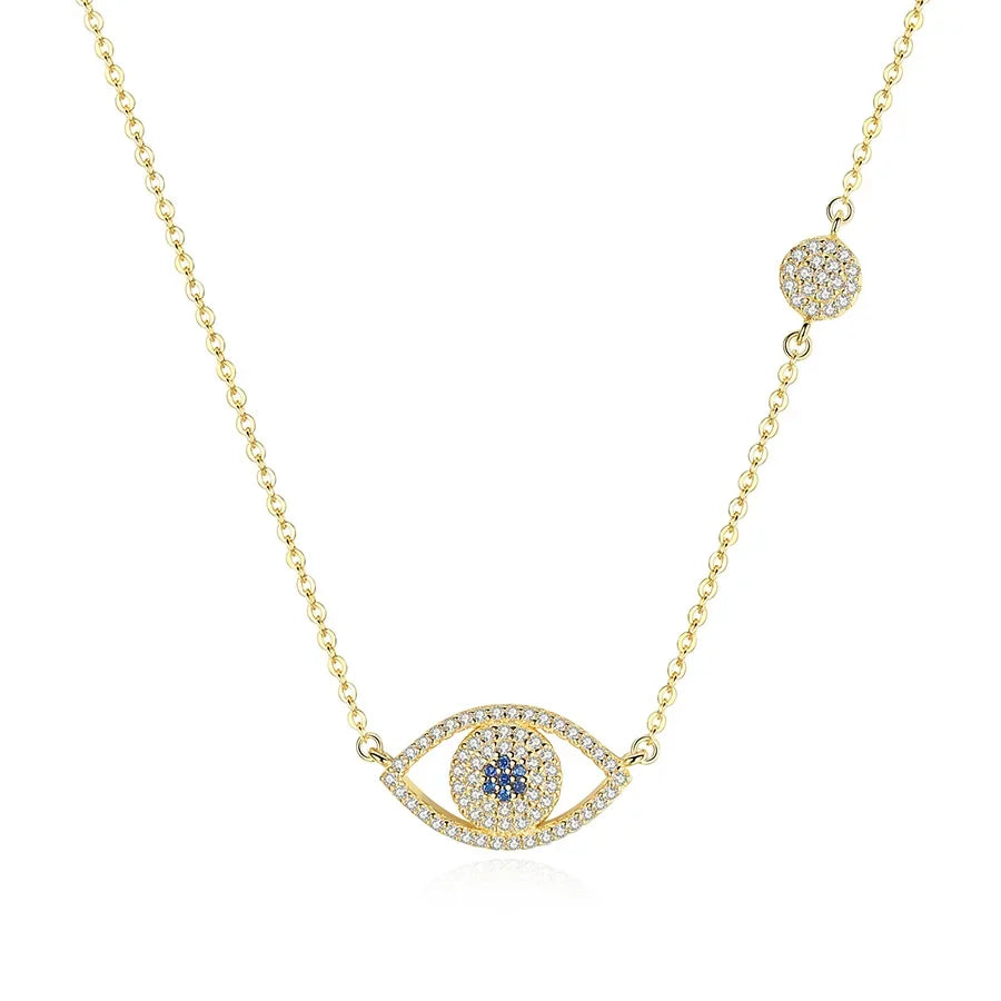 Gold-tone evil eye necklace on white with blue CZ center, clear CZ outline, and chain station