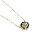 Gold-tone flower evil eye necklace with blue outer CZ stones and a yellow flower center on white