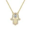 Gold hamsa hand necklace with clear CZ stones, round center stone, and textured beaded palm