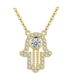 Gold hamsa hand necklace with a round CZ stone, stone-set border, and beaded open palm on white