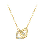 Gold-tone interlocking heart necklace with a clear CZ stone row on a white background