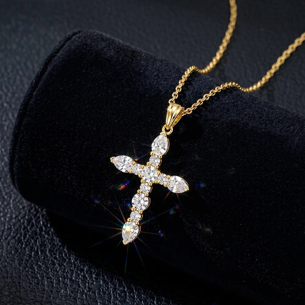 Gold-tone marquise cross necklace with clear moissanite stones displayed on black velvet