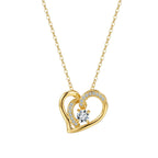 Gold-tone overlapping heart necklace with polished curves, clear accent stones, and center moissanite on white