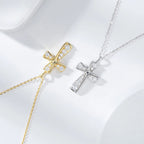 Gold-tone and silver-tone curved cross necklaces with clear CZ stones on a white surface