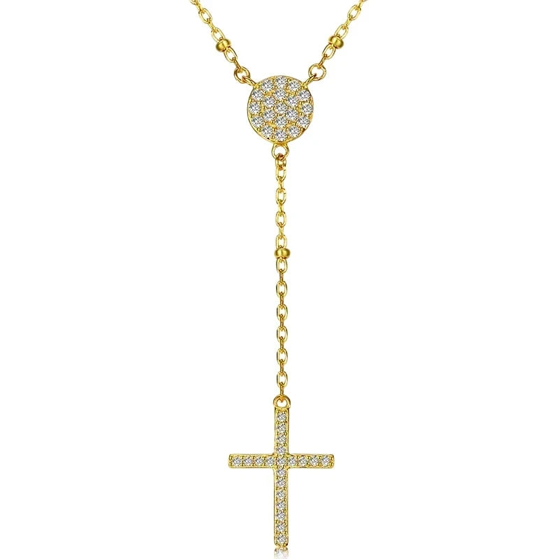 Gold-tone rosary drop necklace with a round CZ center and slim sparkling cross on white