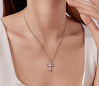 Sterling silver Gothic cross necklace worn on the neck, showing the small stone-set pendant