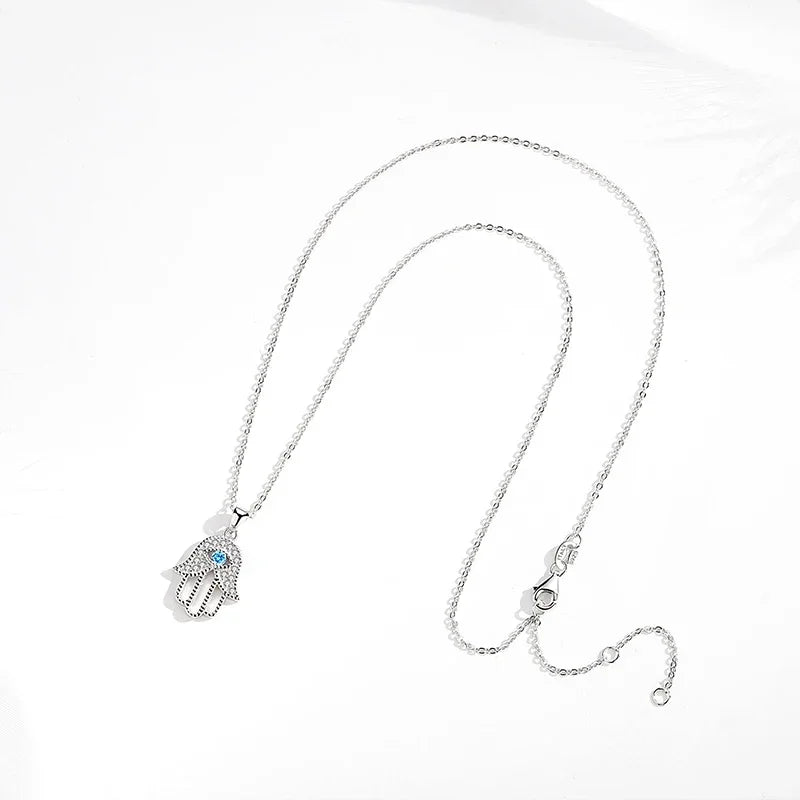 Silver-Tone evil eye hamsa necklace laid flat, showing the oval-link chain, clasp, and extender