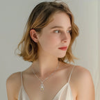 Model wearing the silver-colored hamsa hand necklace with a blue eye pendant at the collarbone
