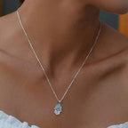 925 sterling silver hamsa necklace worn on the neck with a blue stone halo and star center