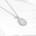 Back view of the sterling silver hamsa pendant showing the openwork hand and blue eye setting