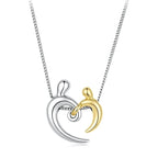 Heart hug necklace with silver-colored and gold-colored embracing figures on a white background