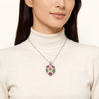Silver 925 sterling silver heart necklace worn at the collarbone over a white turtleneck