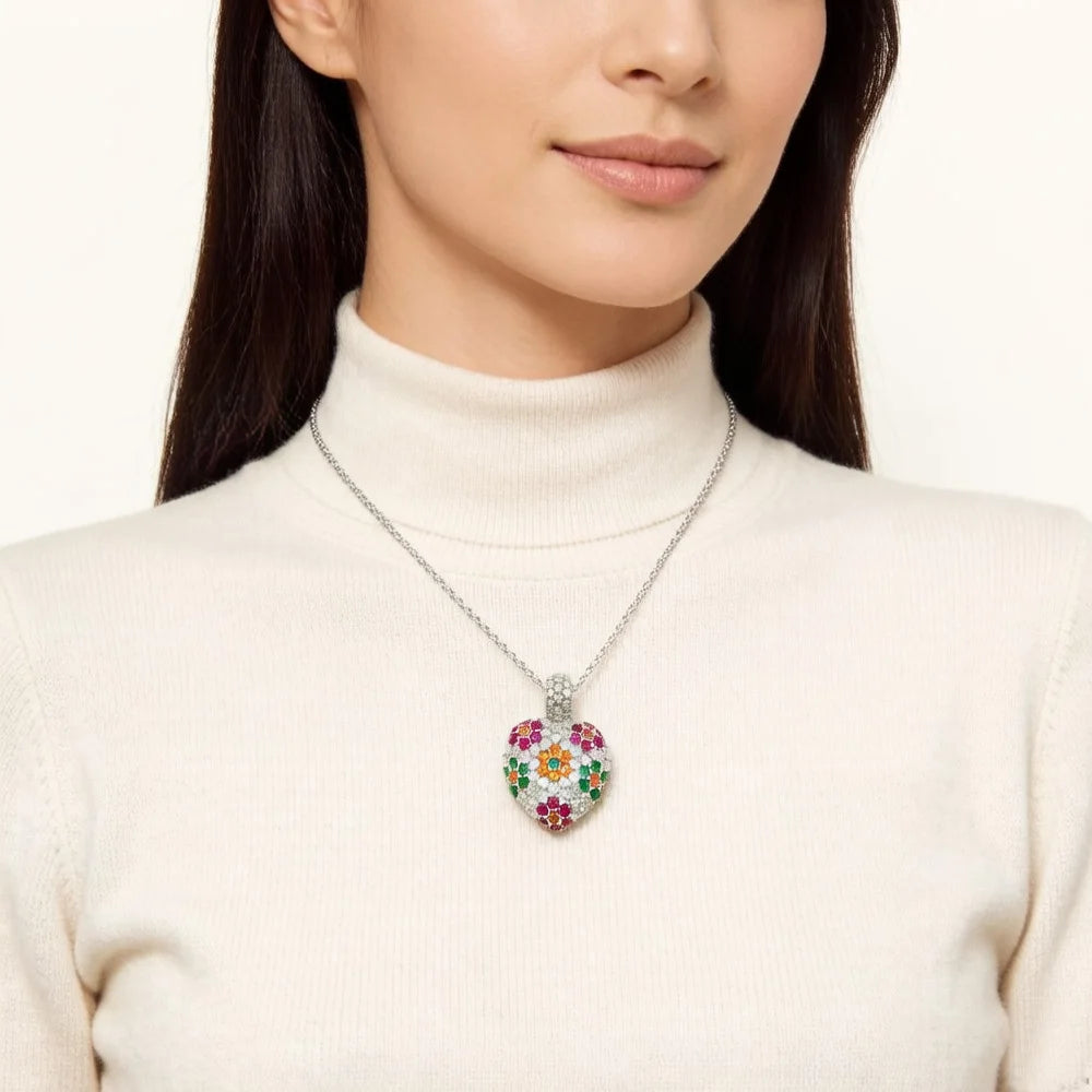 Silver 925 sterling silver heart necklace worn at the collarbone over a white turtleneck