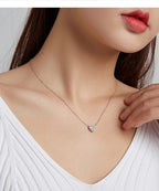 Sparkling heart necklace worn with the pendant centered at the upper chest