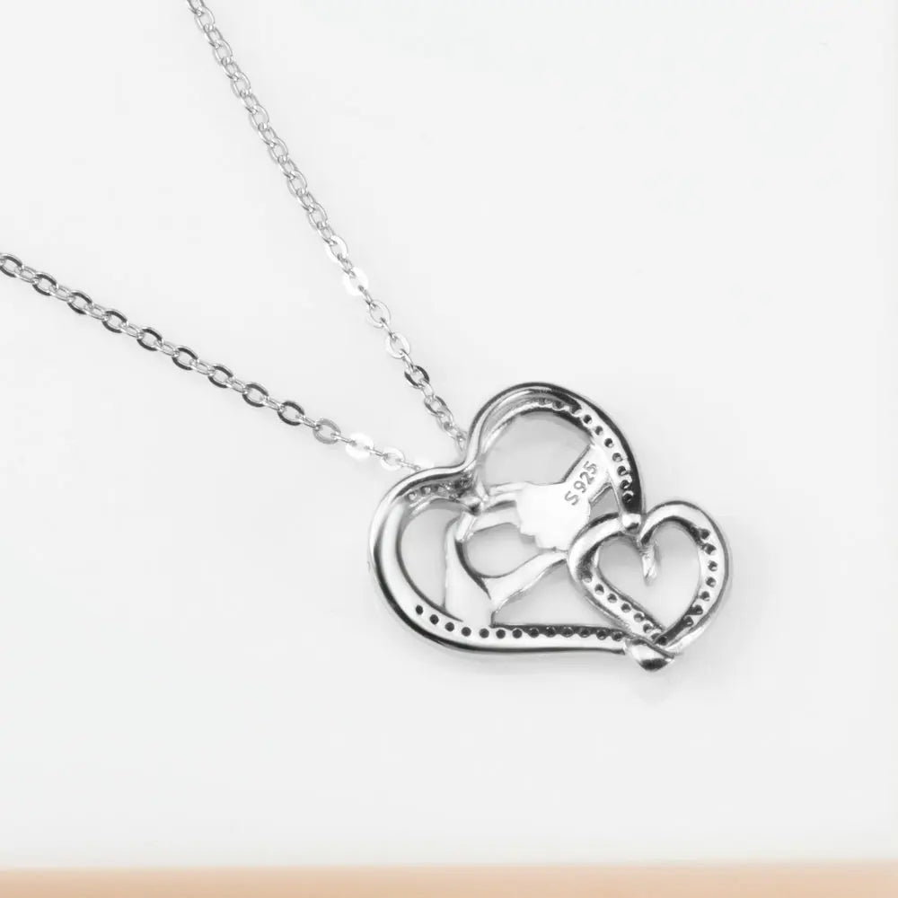 Back view of the 925 sterling silver heart pendant showing its openwork design and S925 hallmark