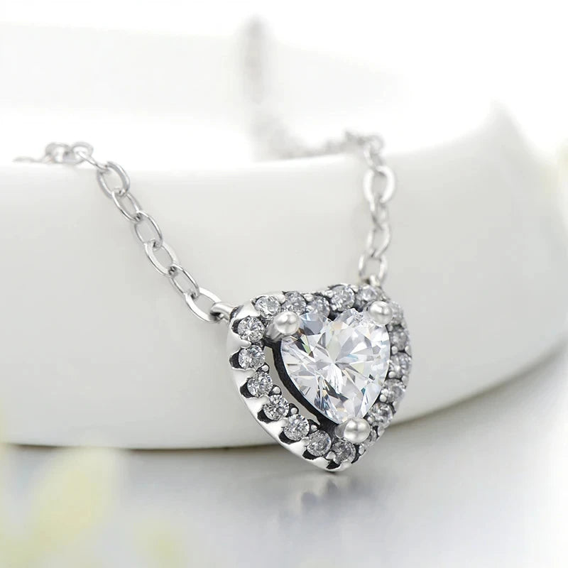 925 sterling silver heart pendant necklace with a clear cubic zirconia center on a white display