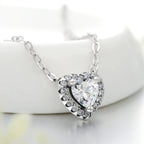 925 sterling silver heart pendant necklace with a clear cubic zirconia center on a white display