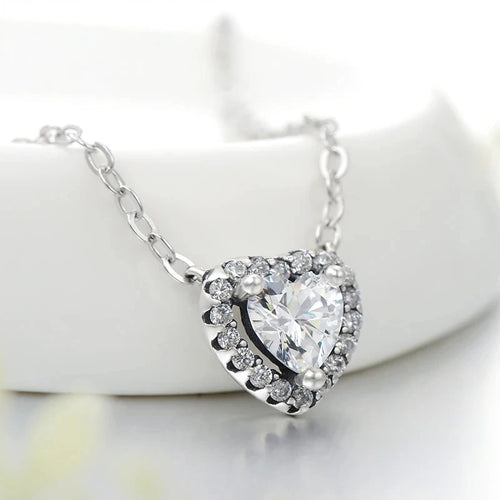 925 sterling silver heart pendant necklace with a clear cubic zirconia center on a white display