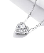Close-up of the heart pendant with raised center stone and tiny heart cutouts along the side