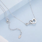 Close view of the infinity heart pendant, link chain, lobster clasp and extension chain